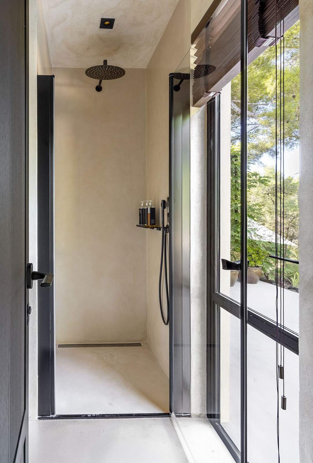 Walk-in rain shower with glass screen and view to the garden