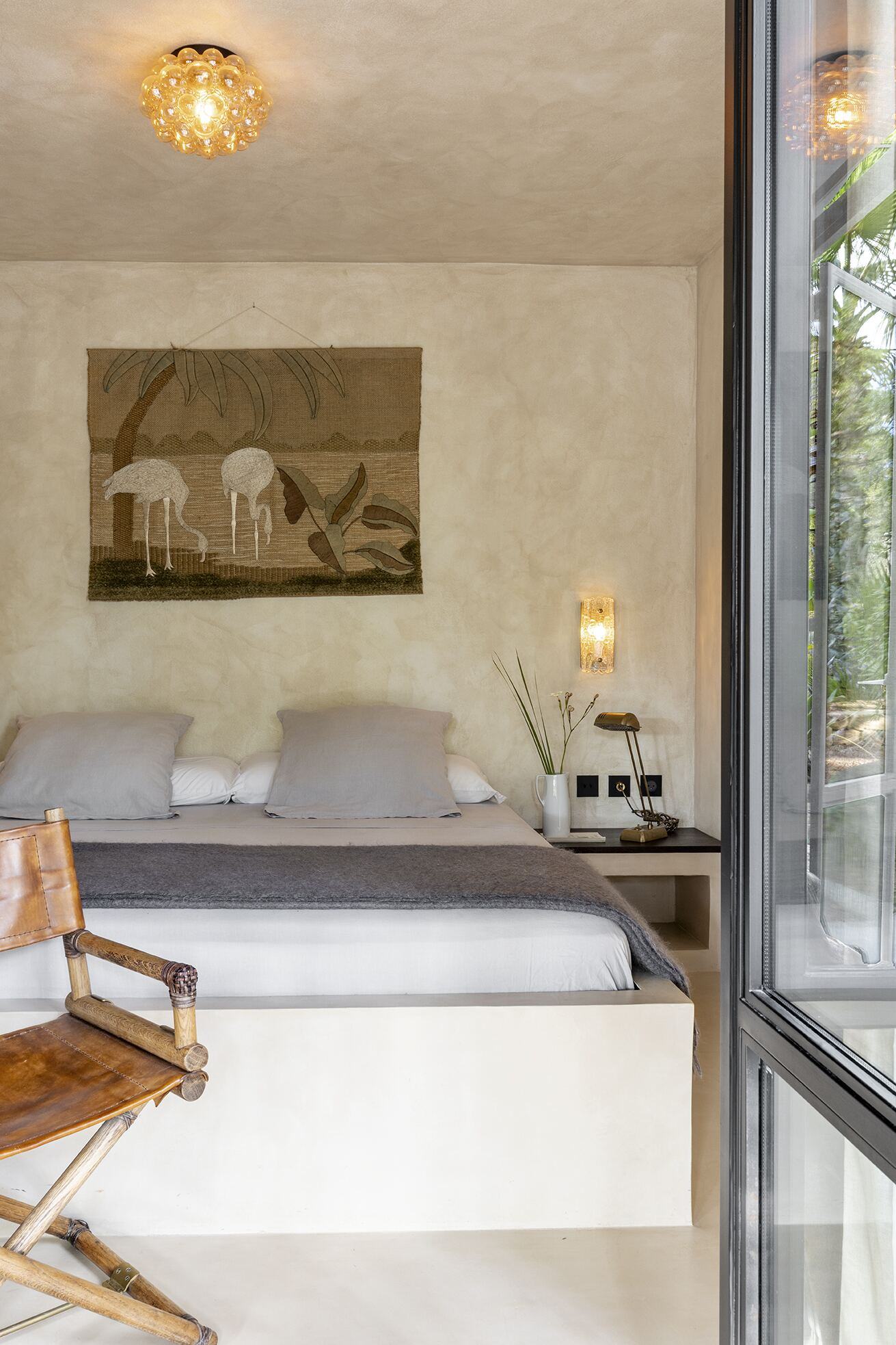 Guest bedroom with linen bedding and pine view