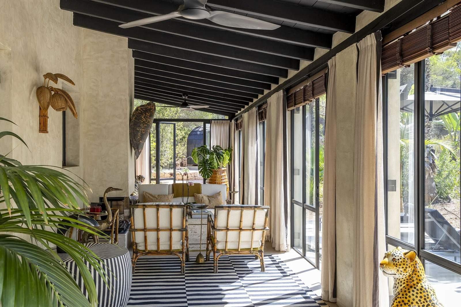 View along the sunroom toward the pines and pool
