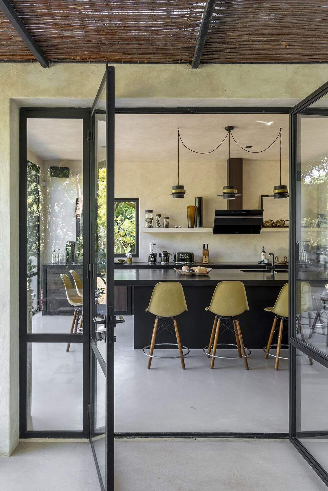 View through open steel doors into the kitchen island