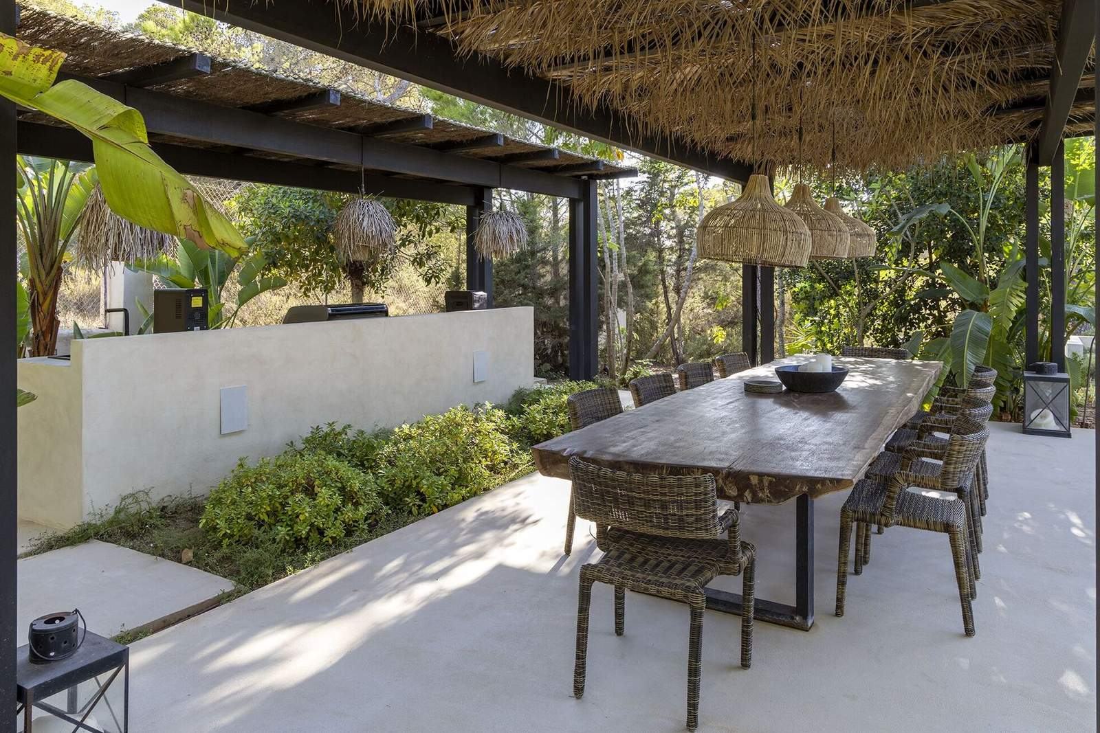 Pavilion dining table beside the outdoor kitchen and BBQ area