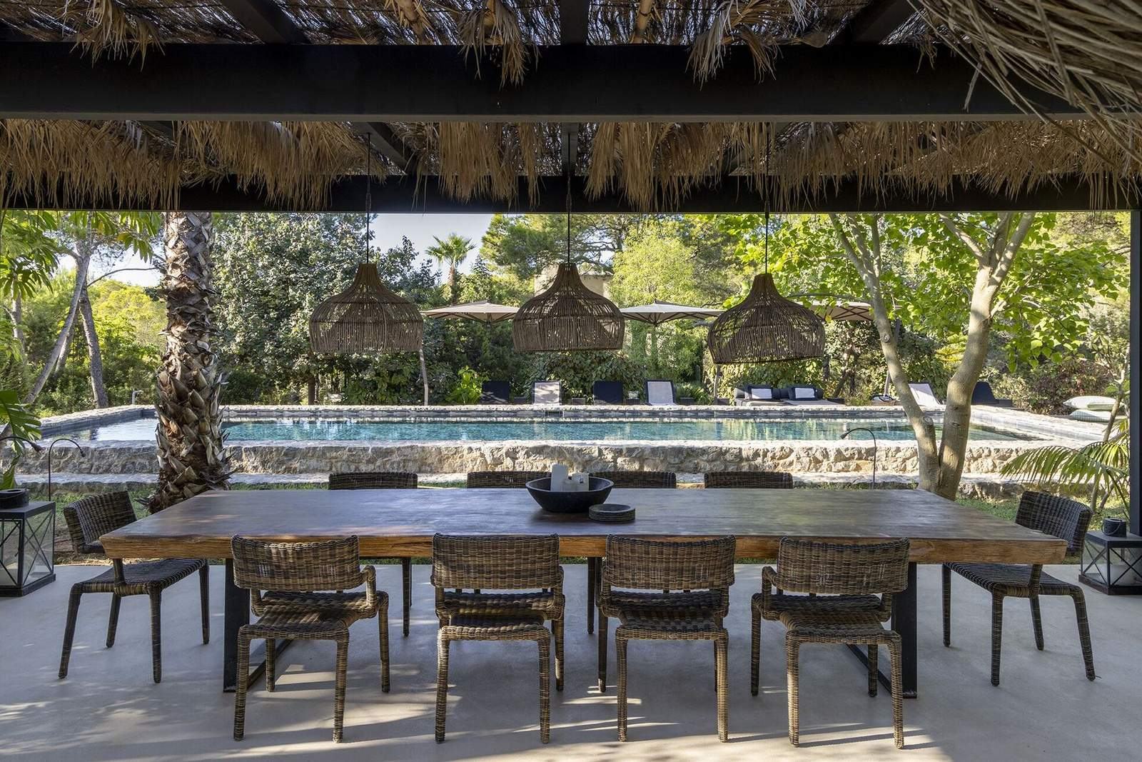 View from the dining pavilion across the pool to loungers under parasols